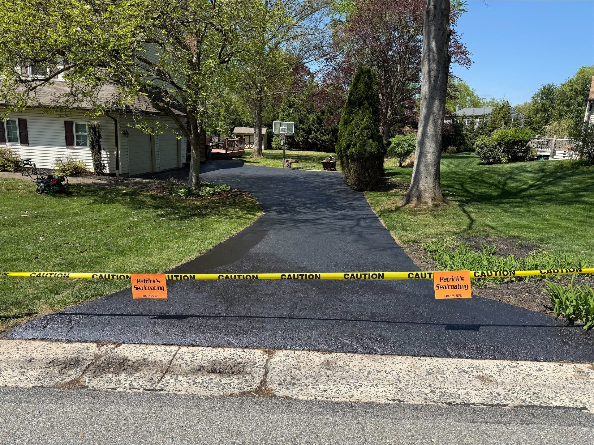 Long residential driveway, freshly sealcoated