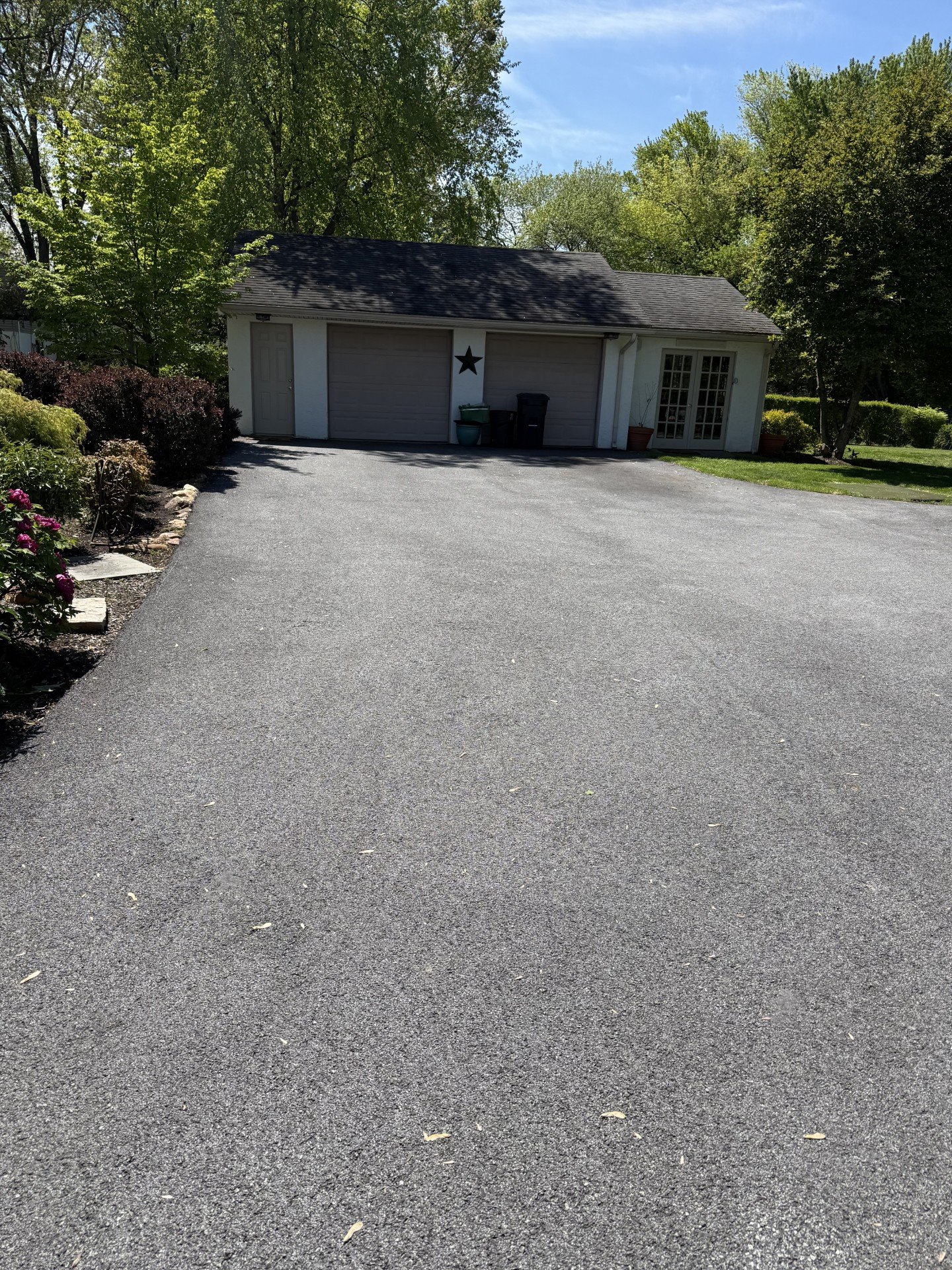Sealcoated driveway second angle showing full coverage to garage